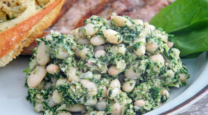 a close up of a plate of white bean spinach puree