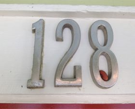 a building number showing 128 with a single red bean in the 8