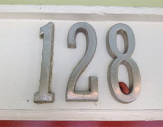 a building number showing 128 with a single red bean in the 8