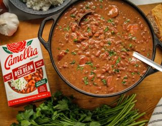 Stovetop Creole Red Beans next to a box of camellia brand red bean seasoning