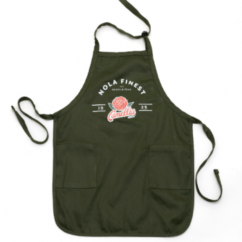 a green nola finest apron with the camellia flower logo