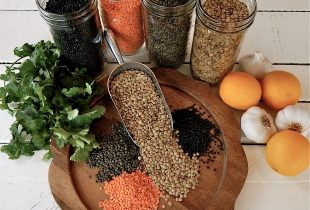 Various Types of Lentils Spill out on a cut board
