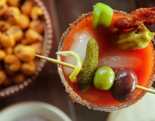 Smoky Bloody Mary next to a bowl of snacks