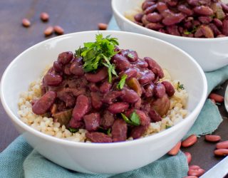 a close up of 2 bowls of red beans and rice