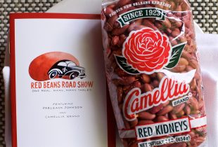 a plate with a flier for the red beans road show next to a package of camelia red beans