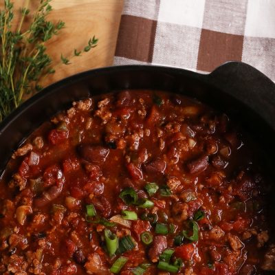 a cast iron pot full of Creole-Style Pork & Red Bean Chili