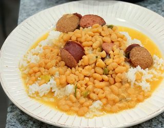 a plate full of Instant Pot Navy Beanswith rice and sausage