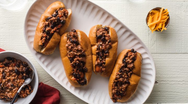 4 kid friendly sloppy joe hot dogs topped with ground beef and black beans on a plate