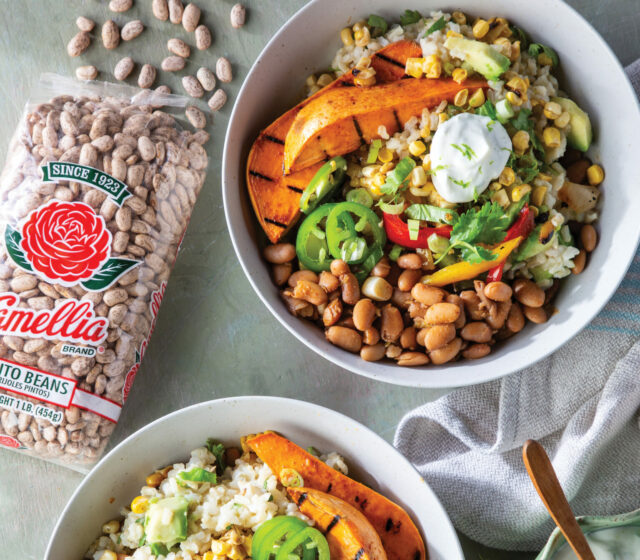 2 bowls of cooked Chiupolte Burrito Bowls next to open, spilled bag of Camellia Pinto Beans