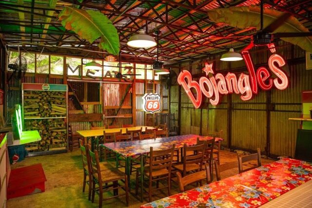 Inside Hot Stuff restaurant with Bojangles light up sign, green and red lights